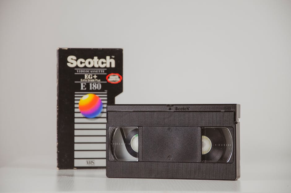Retro VHS cassette with box in studio setting, representing nostalgia and vintage media.